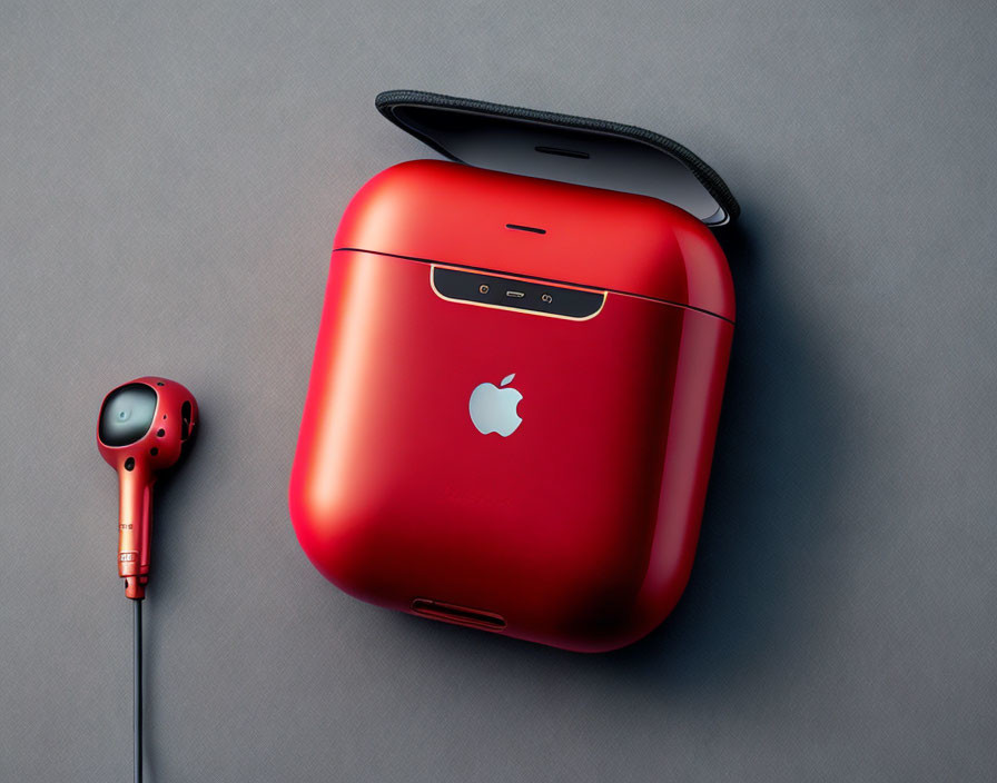 Red Wireless Earbuds Case with Partial Earbud on Gray Surface