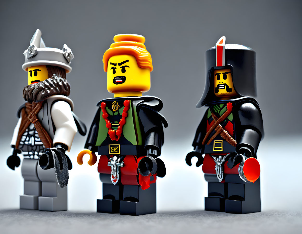 Historical LEGO figurines in intricate costumes on grey background