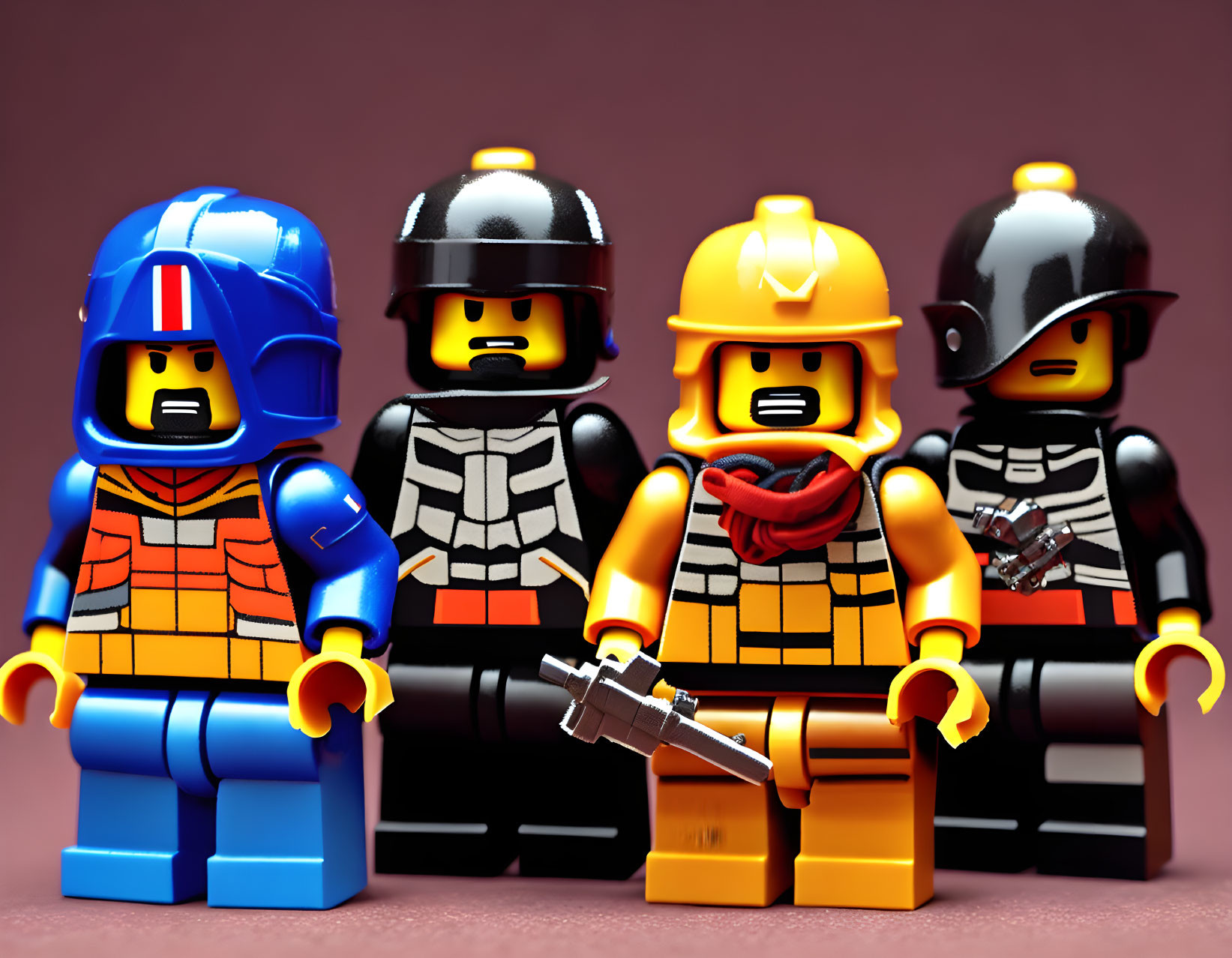 Lego minifigures in firefighter and police officer outfits on pink backdrop
