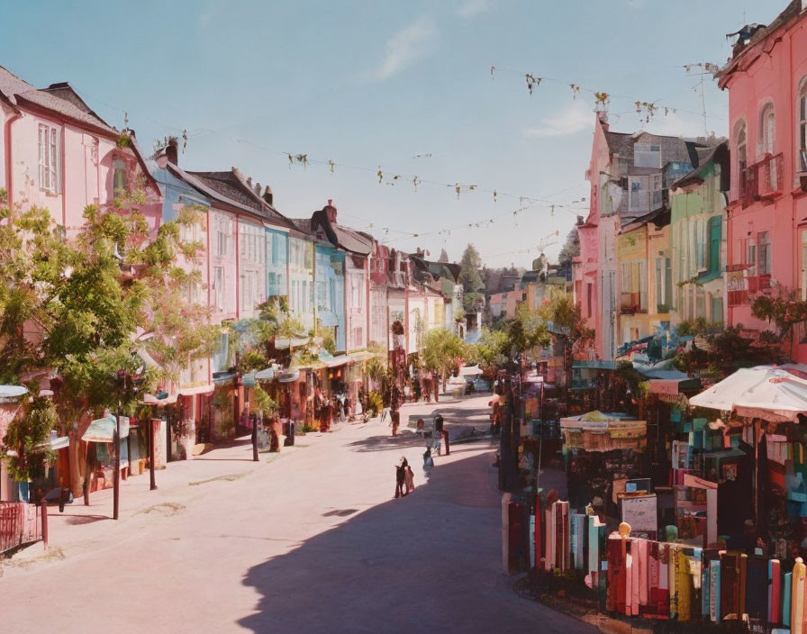 Colorful Houses on Quaint Street with Pedestrians and Festive Lights