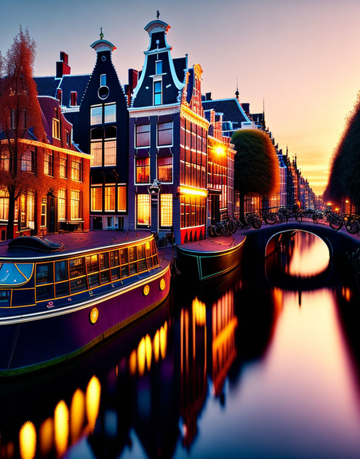 Amsterdam canal at twilight with traditional Dutch houses and stationary boats reflected in calm water