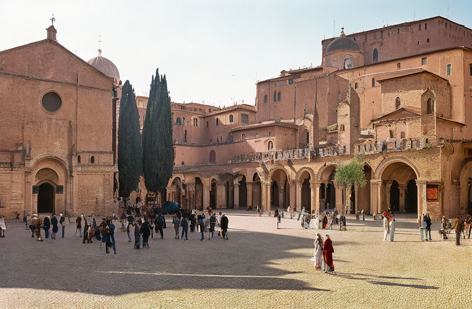 Historic architecture and bustling square with people and couple under clear blue sky