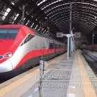 Red and White High-Speed Train at Station with Arched Glass Roof