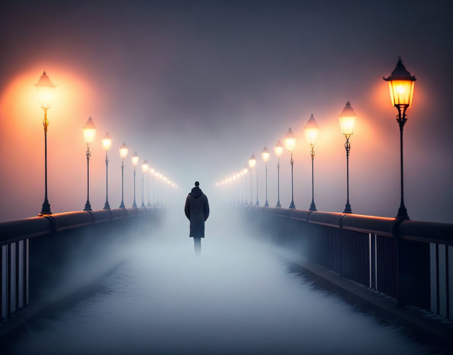 Foggy bridge with lone figure and glowing street lamps