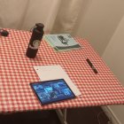 Neatly organized table with red & white checkered tablecloth & various items