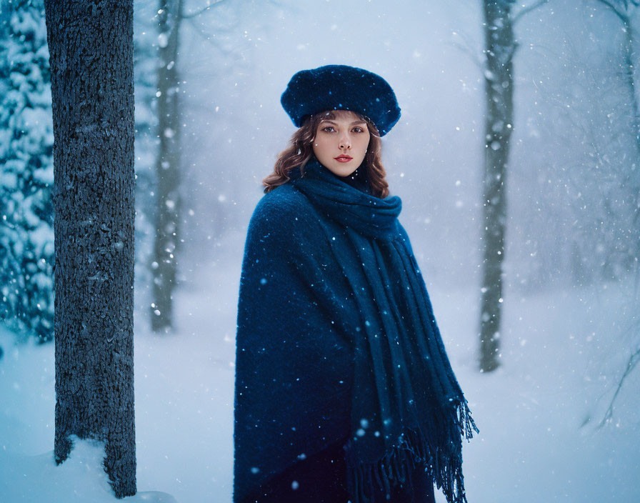 Woman in beret and scarf in snowy forest with falling snowflakes