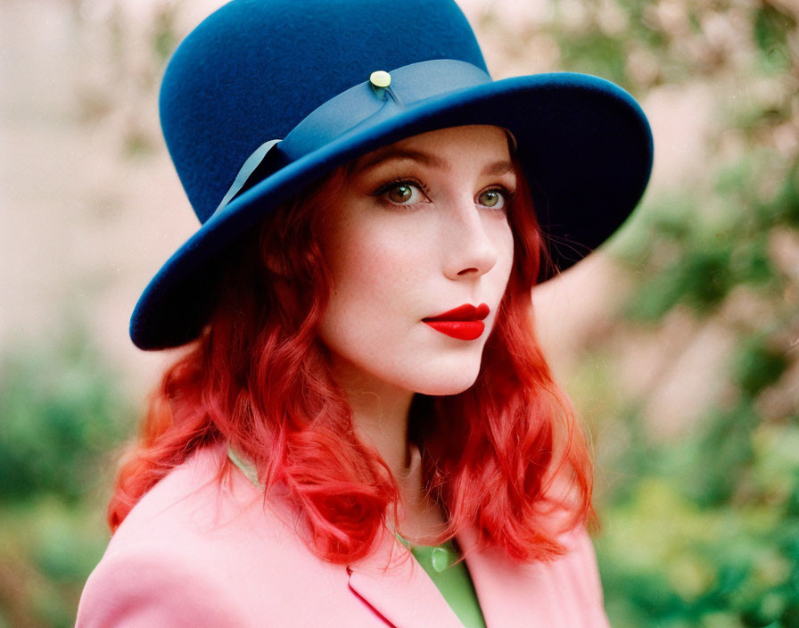 Vibrant red-haired woman in blue hat and pink coat gazes sideways