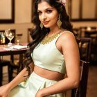 Elegant woman in jewelry sitting in luxurious room