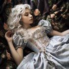 Curly white hair woman in blue and gold gown surrounded by greenery and roses