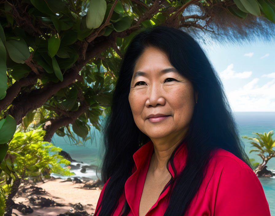 Smiling woman with long black hair by ocean view