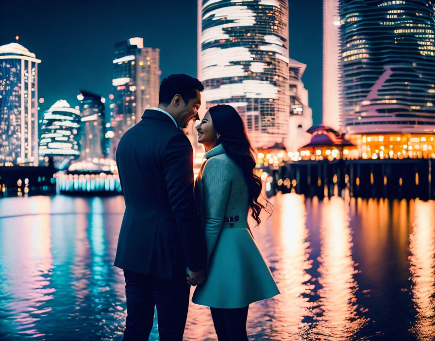 Intimate couple near city waterfront at night