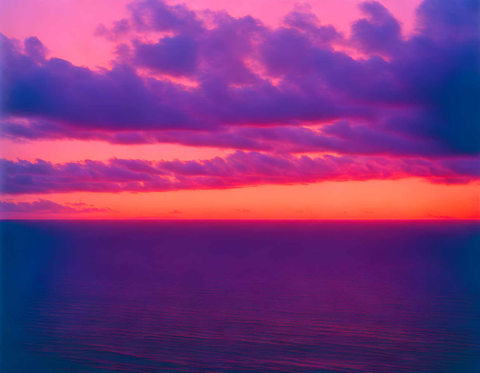 Pink and Purple Sunset Sky Reflecting on Ocean Surface