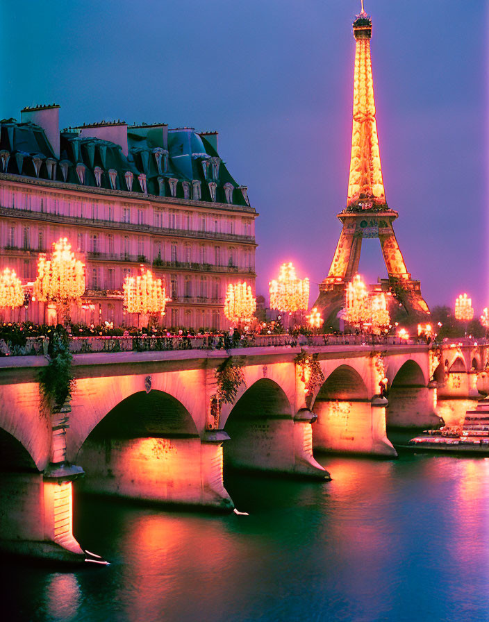 Twilight view of illuminated Eiffel Tower & Seine River bridge