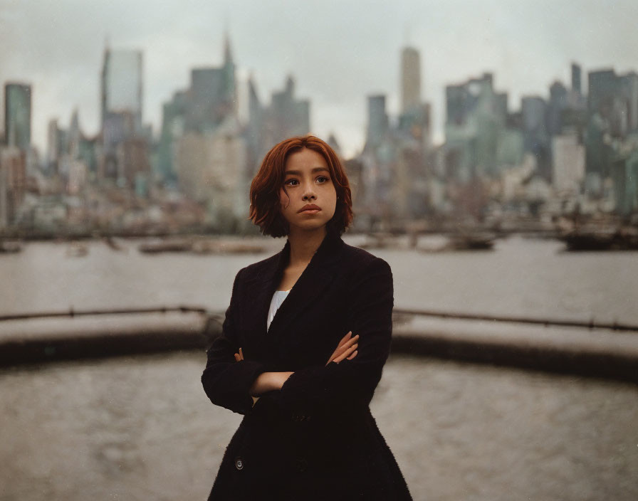 Confident woman with short hair against overcast city skyline