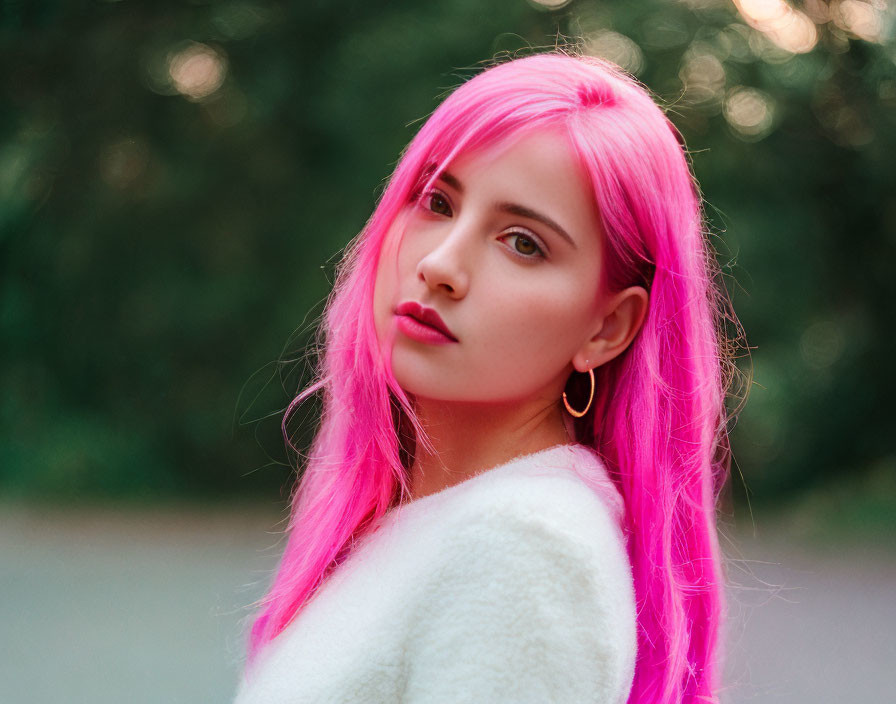 Bright Pink-Haired Person in White Outfit Against Green Background