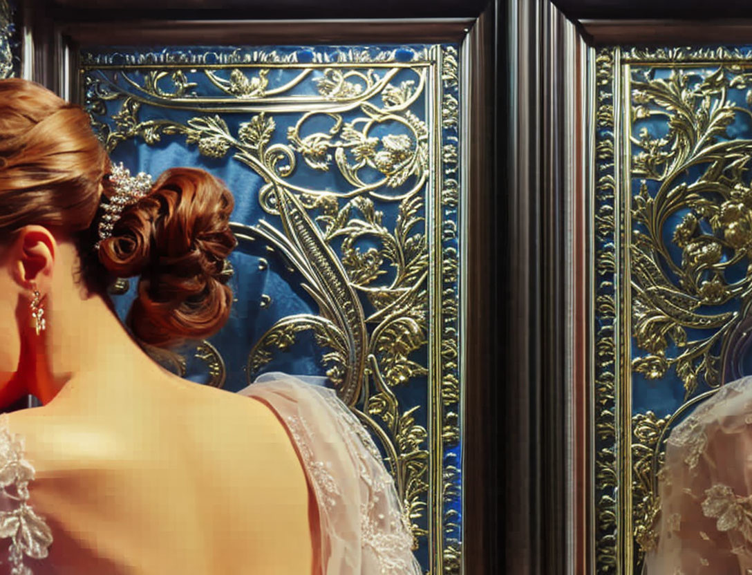 Woman in lace dress with updo standing by ornate mirror