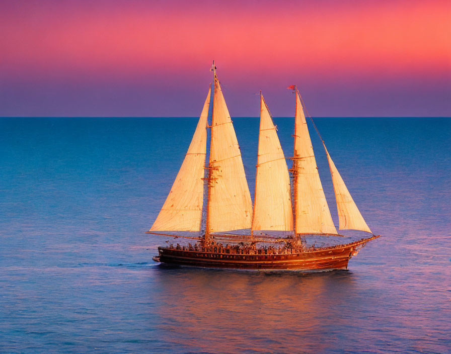 Three-masted sailboat sailing on calm seas at dusk