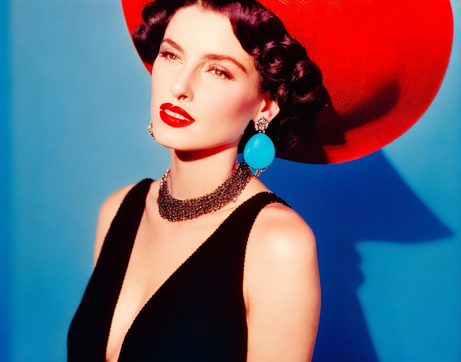 Stylish woman in red hat and black dress with red lipstick