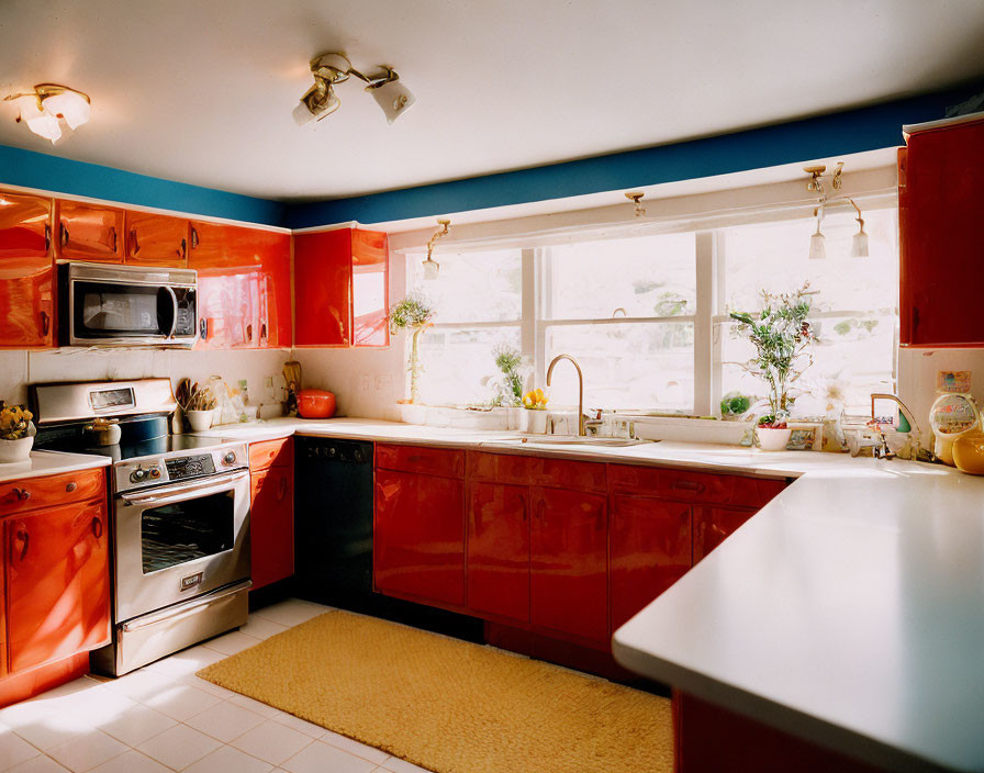 Bright Red Cabinets, White Countertops, Blue Walls in Retro Kitchen