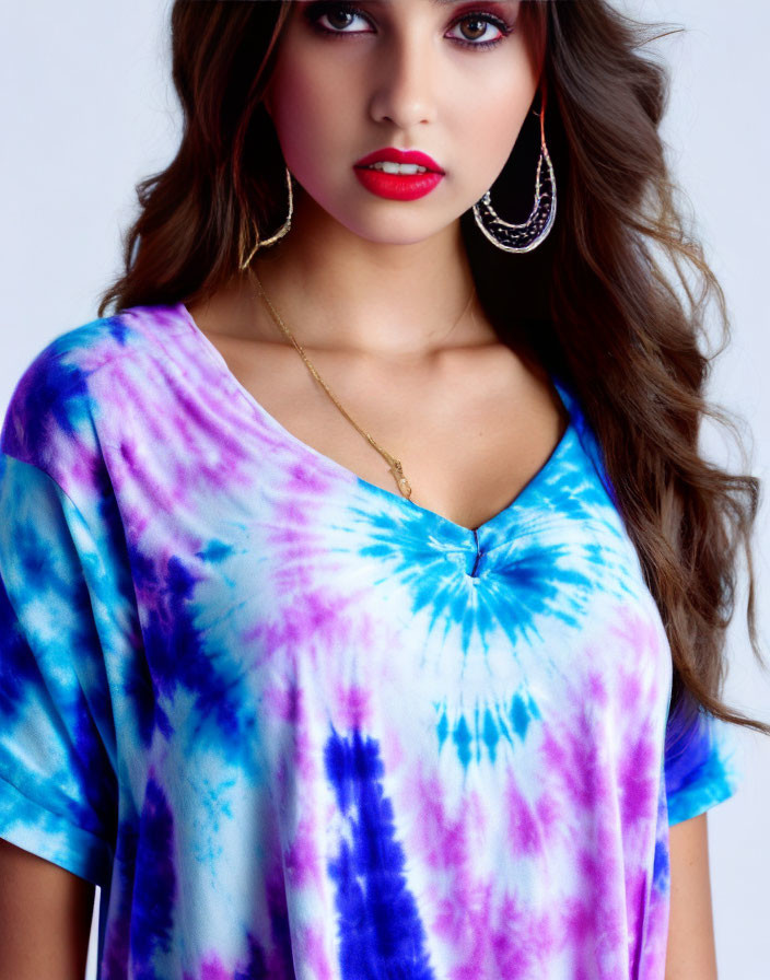 Woman in Blue and Purple Tie-Dye Top with Gold Accessories