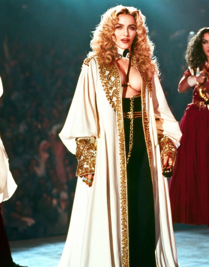 Performer in Gold-Trimmed Cloak and Corset on Stage