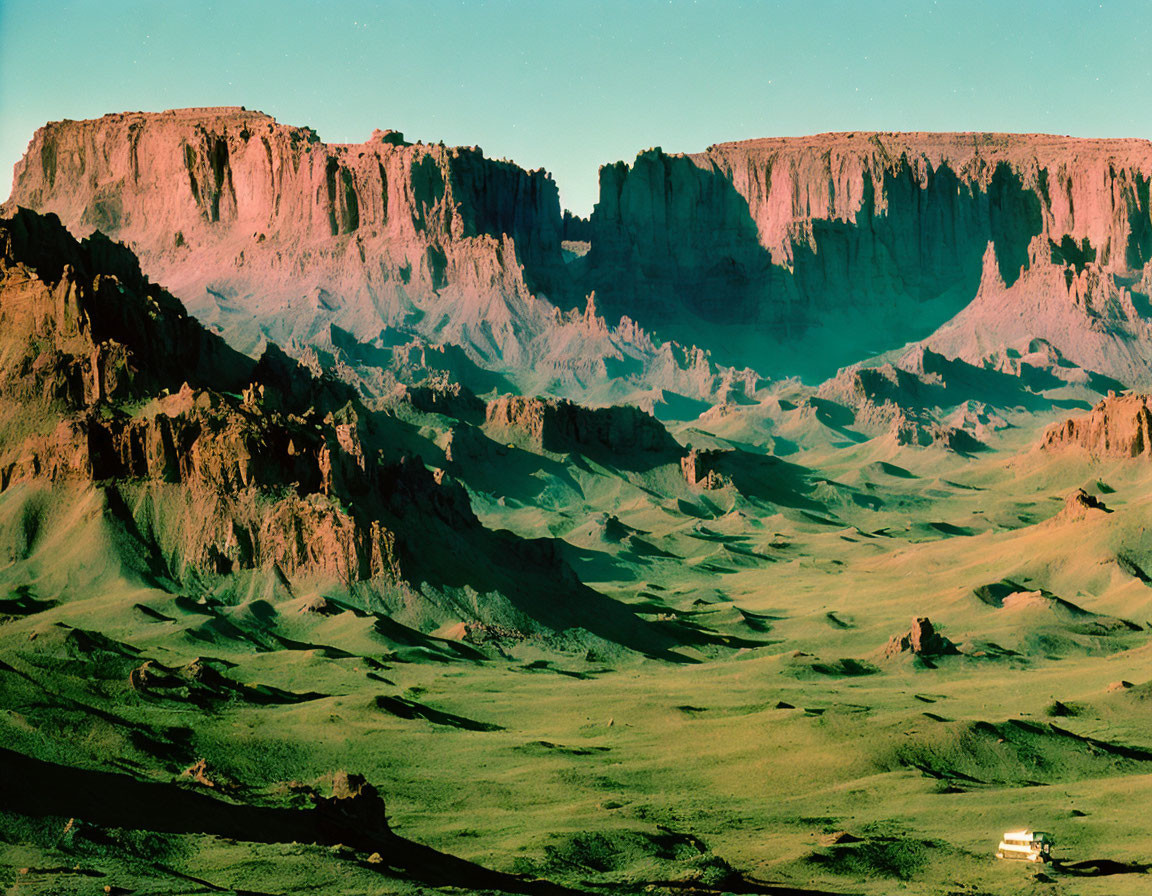 Desert Landscape with Towering Cliffs and Vehicle