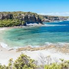 Tranquil Beach Scene with Clear Waters and White Sands