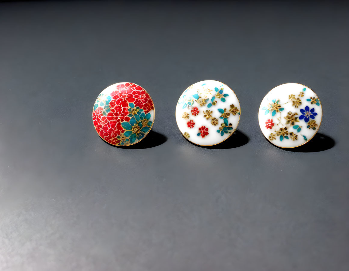 Ceramic knobs: 3 round floral designs on dark surface