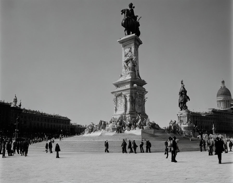 Monument and statues in crowded public square photograph