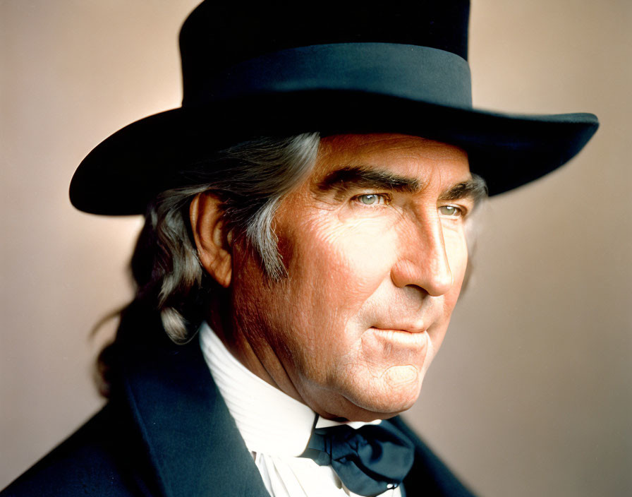 Serious man in black top hat, coat, bow tie, long sideburns