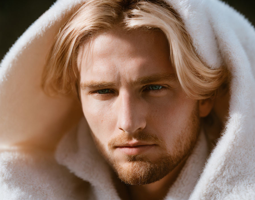 Blond-Haired Young Man in White Hoodie Contemplating