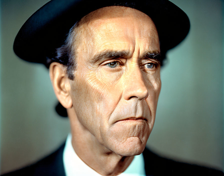 Serious man in black beret and suit with striking features