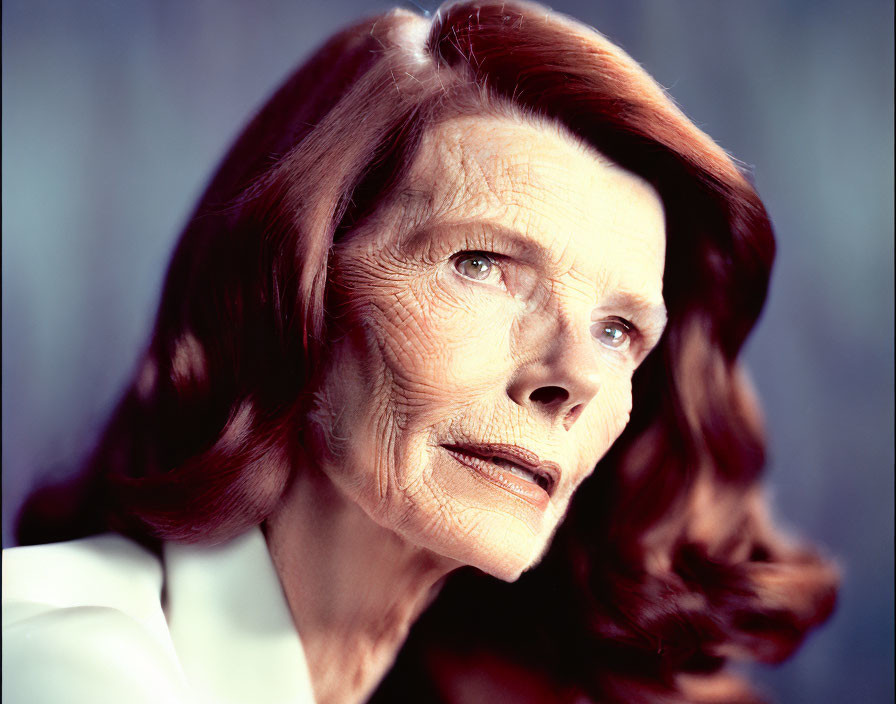 Elderly woman portrait with wrinkles and auburn hair