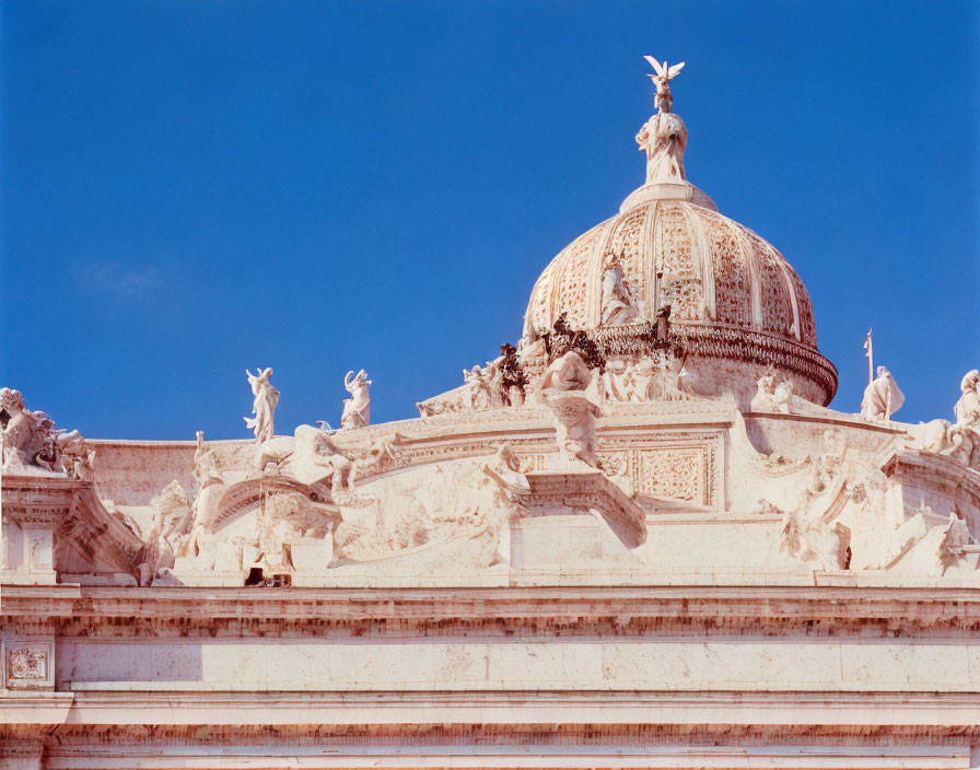 Sculptures and reliefs of angels under a clear blue sky