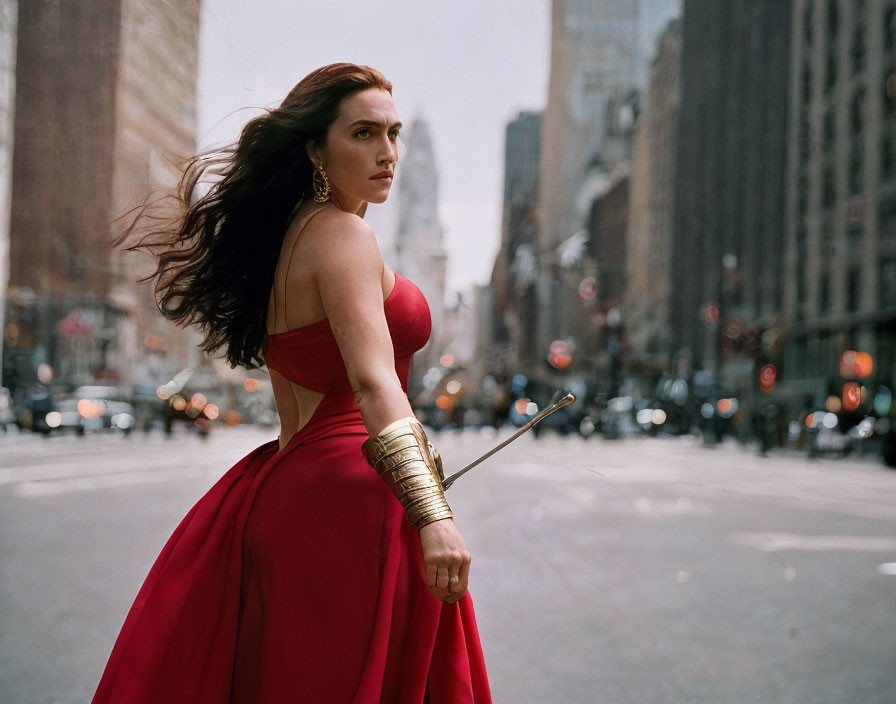 Woman in Red Dress with Bow and Arrow on City Street