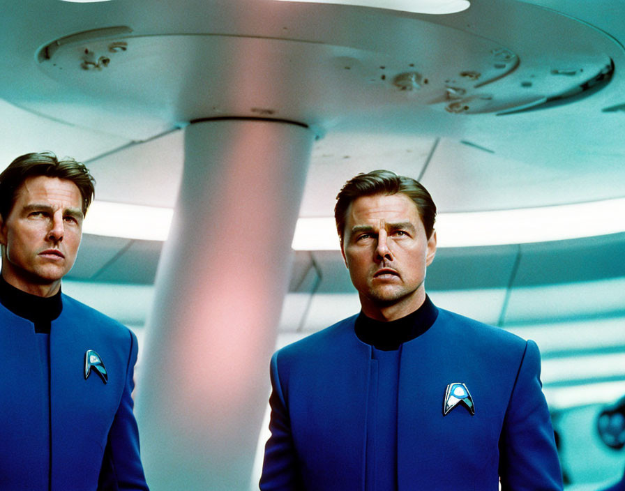 Two Starfleet officers in blue uniforms in futuristic room with beam of light