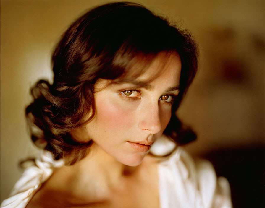 Portrait of Woman with Dark Hair and Intense Gaze in White Blouse