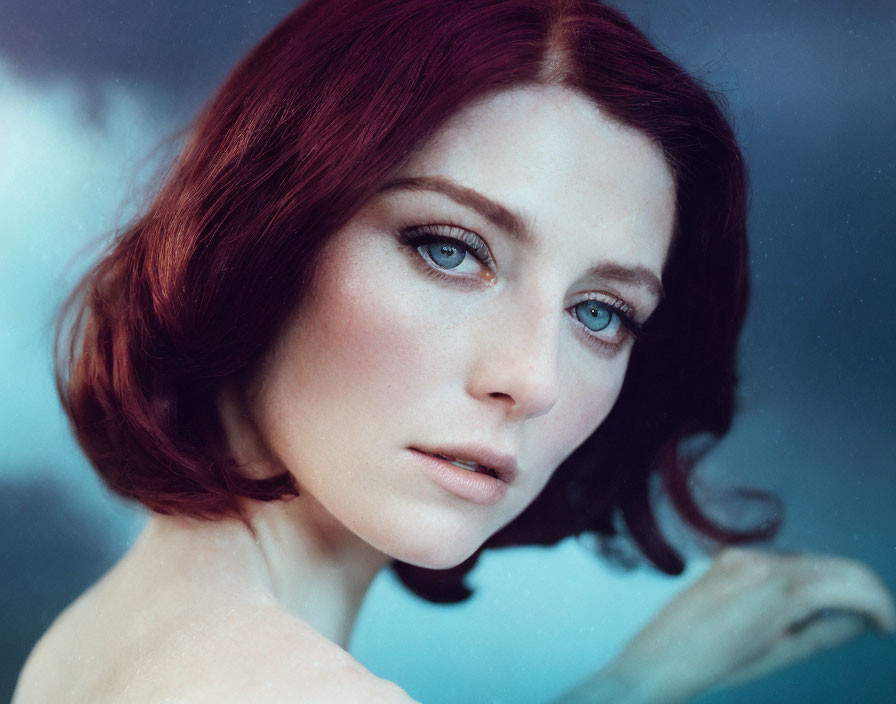 Portrait of Woman with Red Hair, Pale Skin, and Blue Eyes on Dreamy Background