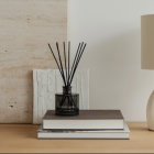 Minimalist Interior Decor with Dried Plants, Glass Vase, White Books, and Modern Lamp