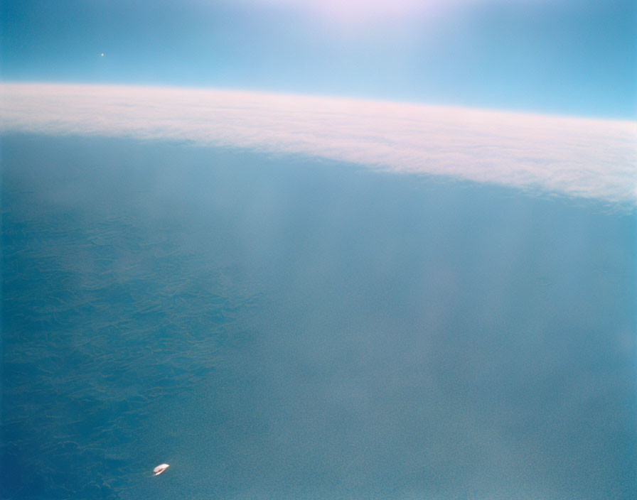 Earth's Horizon with Blue Sky, Clouds, and Sunlit Water