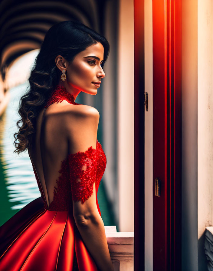 Woman in Red Evening Gown with Lace Detailing Looking Out Window