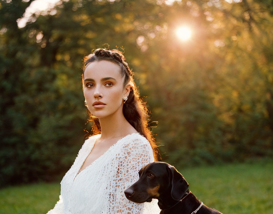 Woman in White Lace Dress with Black Dog at Sunset Outdoors