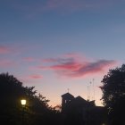 Twilight sky painting with multiple moons over house and trees