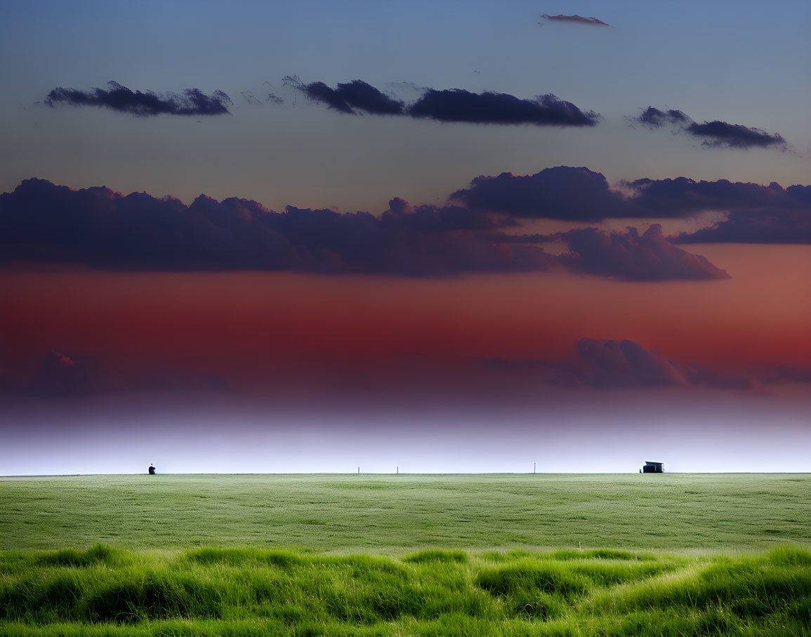 Tranquil landscape with green field, red and blue clouds, and distant truck