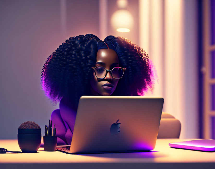 Curly-haired woman with glasses working at desk with purple backlighting and tech accessories