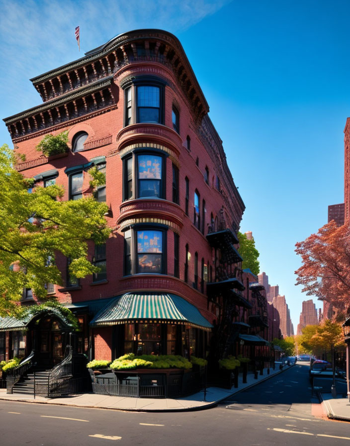 Classic red brick corner building with bay windows and green awning on sunny autumn street