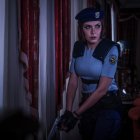 Police woman with rifle navigating dimly-lit hallway