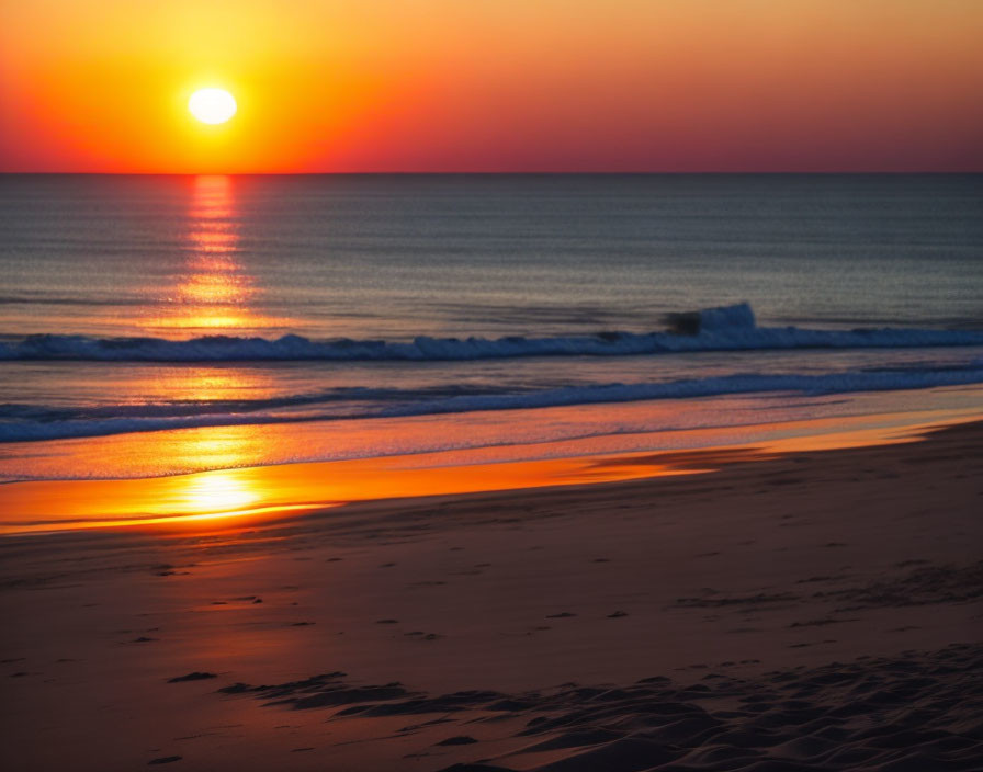 Tranquil sunset scene: sea waves, reflections on wet sand, gradient sky