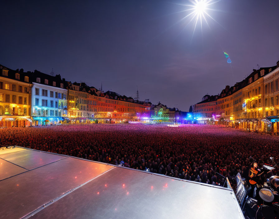 Crowded night scene on brightly lit public square