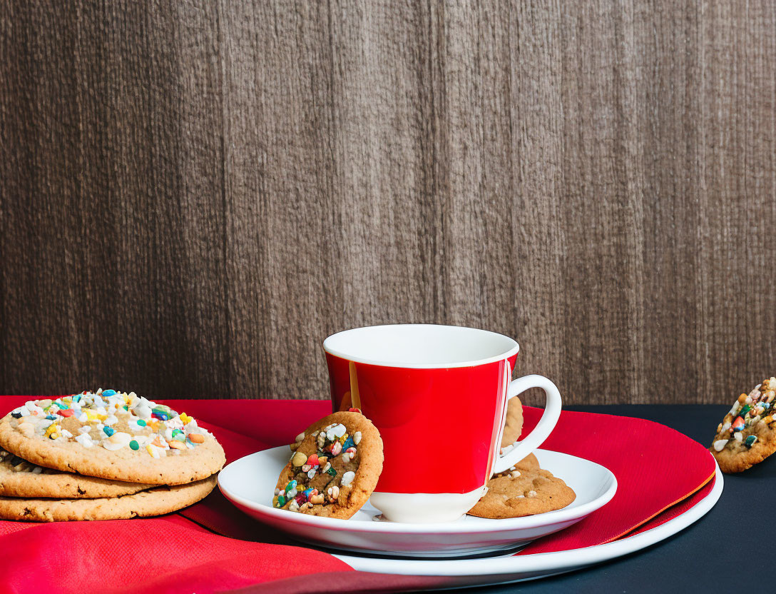 Red and White Cup on Saucer with Colorful Candy Cookies on Plates